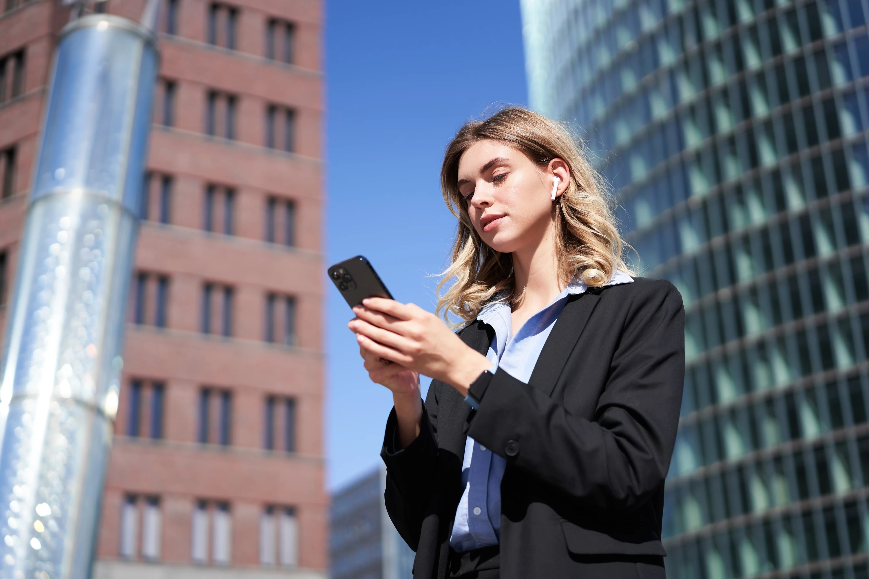An attorney working a matter from her phone between buildings